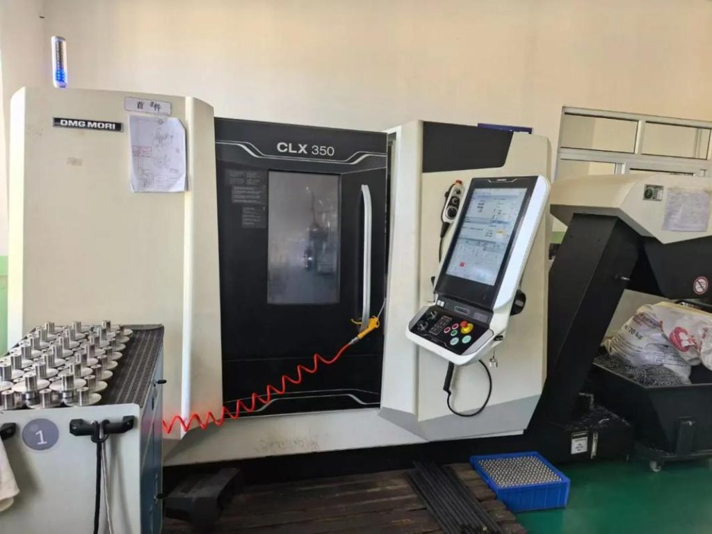 Multi-axis CNC turn-mill machine performing simultaneous turning and milling operations for precision parts